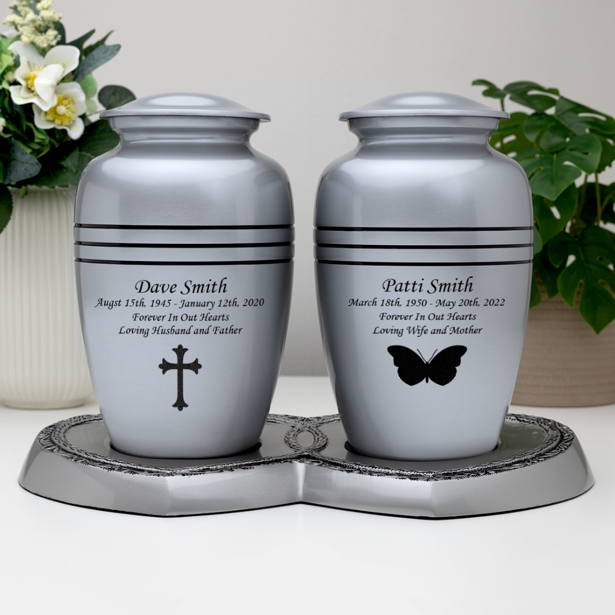 Pewter companion urns with metal base.