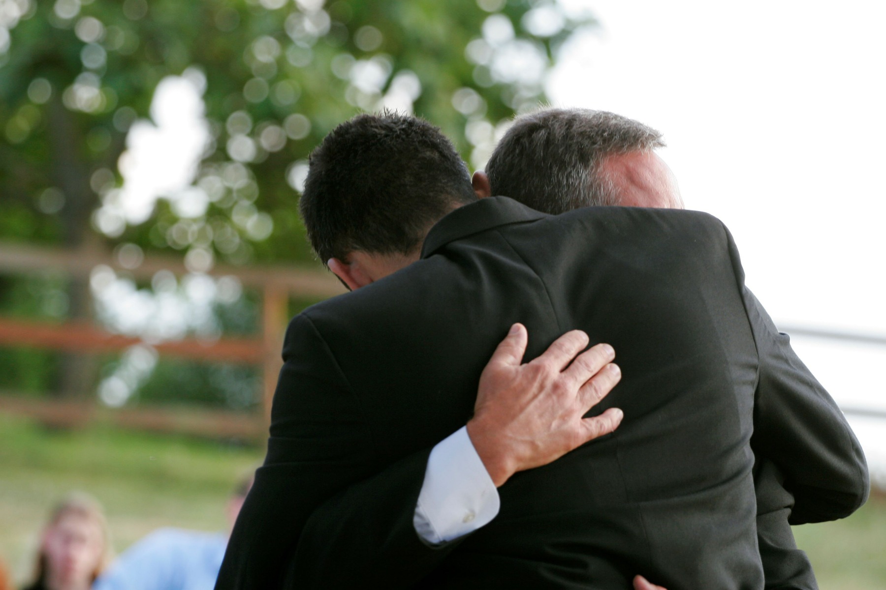Two men hugging.